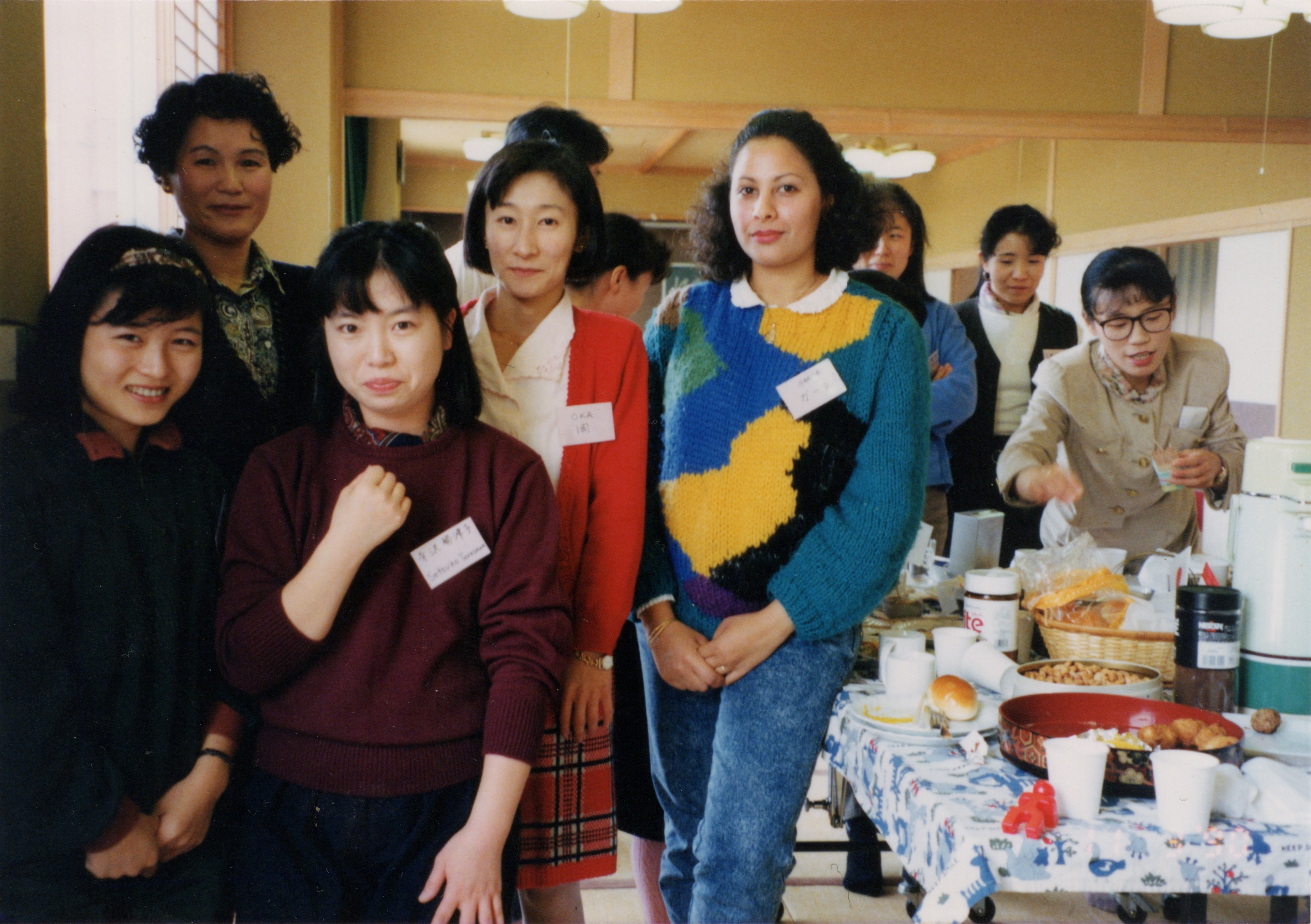 Ghada with a group around a table in Japan